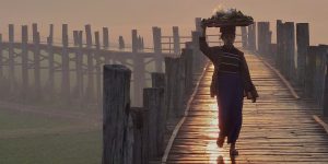 a-local-woman-walking-on-u-bein-bridge-at-sunset